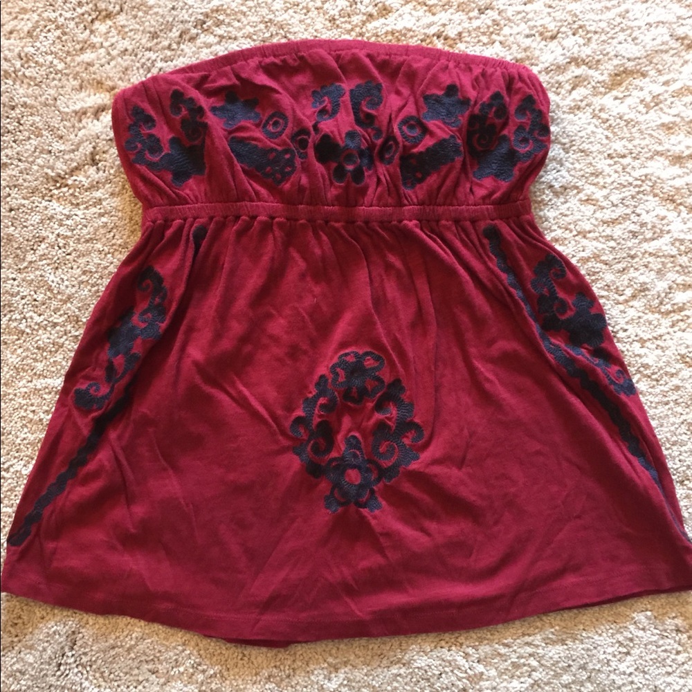 Deep red tube top with dark blue design.